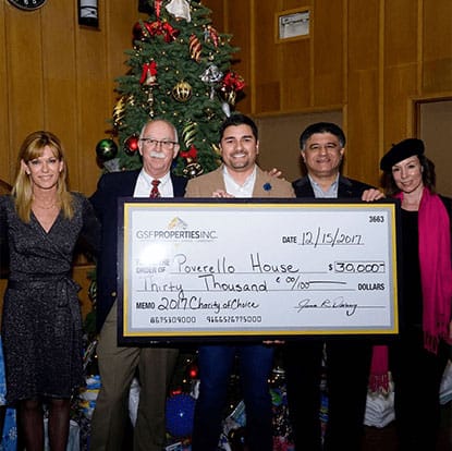 group of people holding a big check